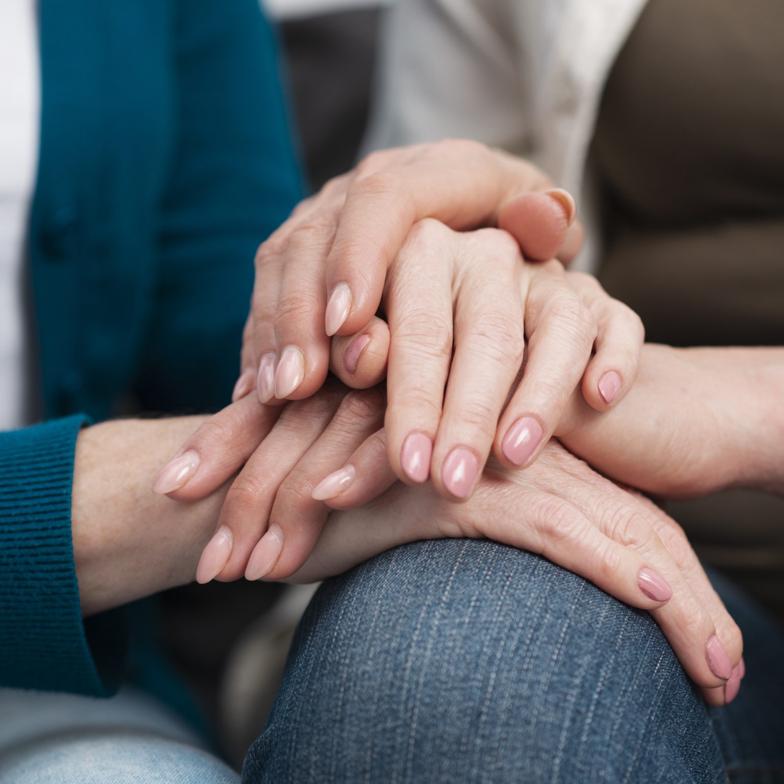 Women supporting one another by holding hands